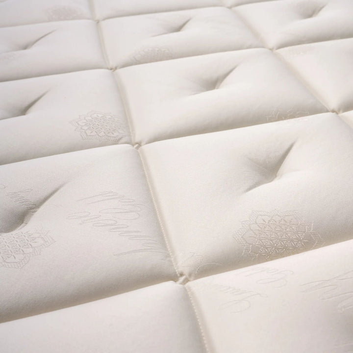 Close-up of the quilted top surface showcasing stitching, texture, and natural fiber detailing.