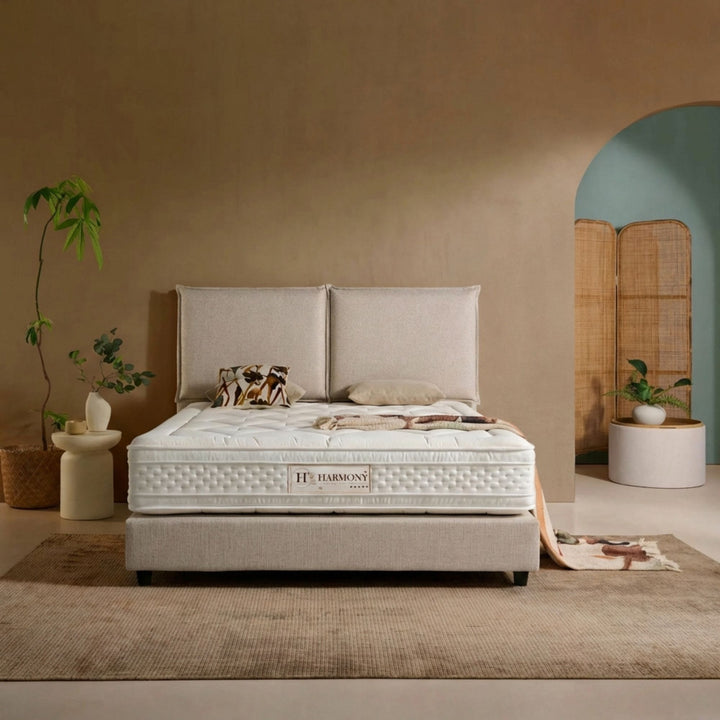 Styled bedroom setting featuring the Harmony Mattress on a modern upholstered base.