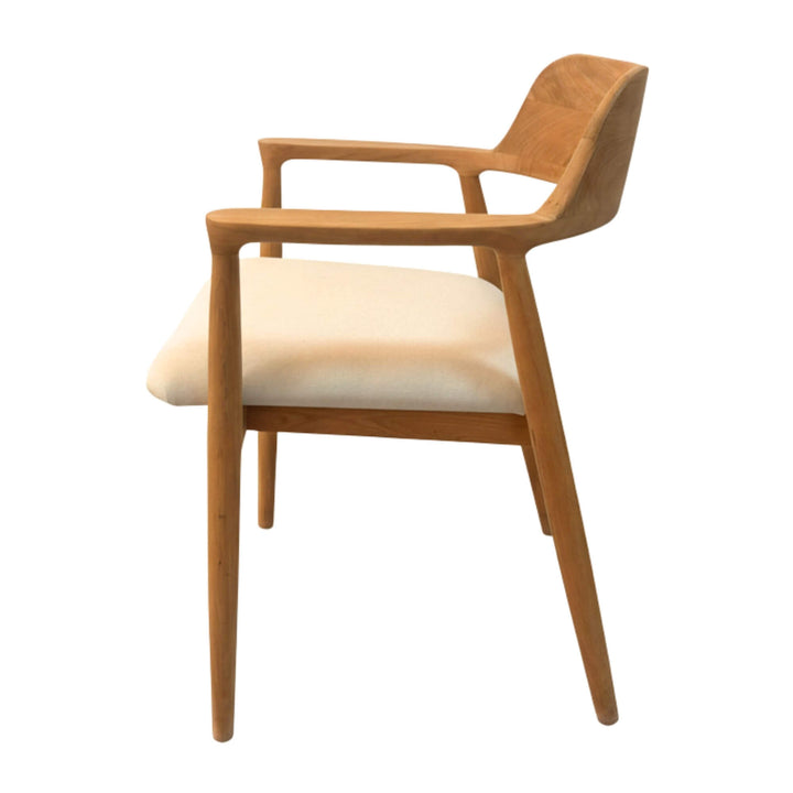 Side view of the Haru Dining Chair showing the sculpted teak arm detail.