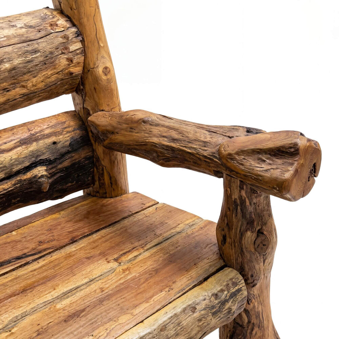Close-up detail of the armrest and seat showing the aged teak texture and rustic joinery.