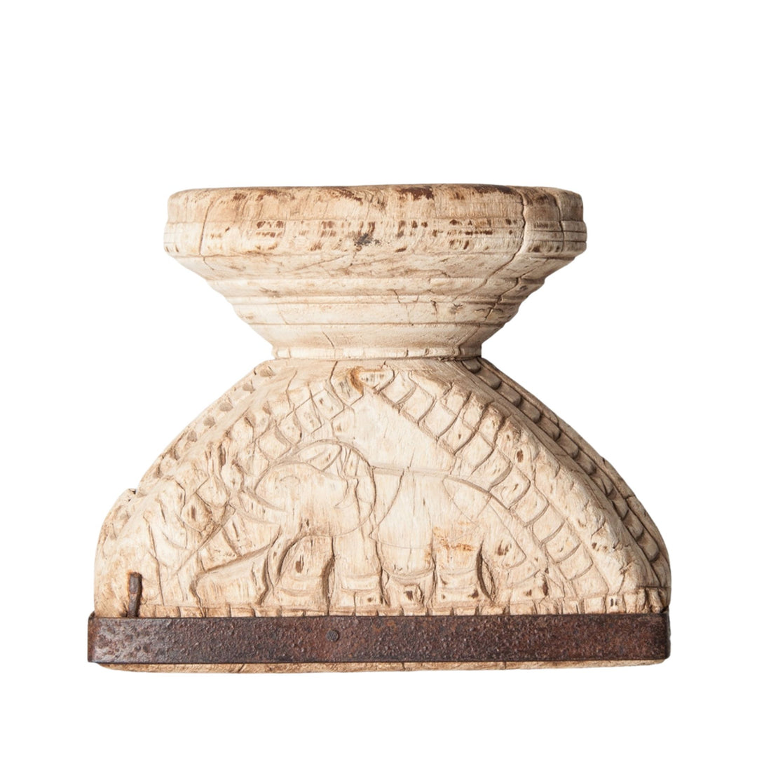 Front view of the Helike Candle Holder showing hand-carved wooden details and iron base.