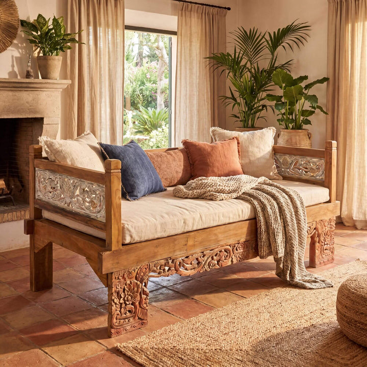 Styled interior setting featuring the Hemera daybed in a relaxed natural living space with decorative cushions.