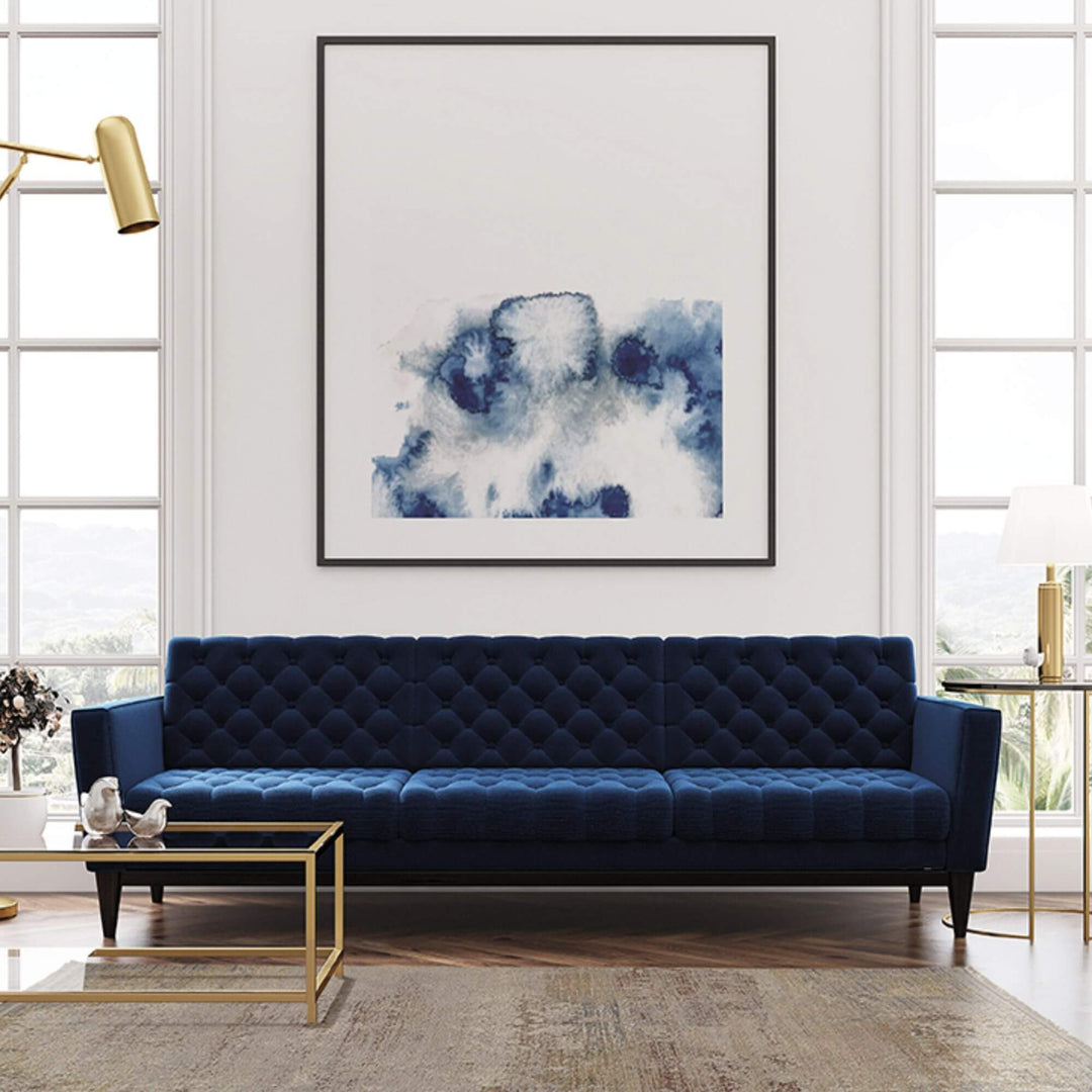 Living room setting with the Himalaya rug placed under a navy blue sofa.