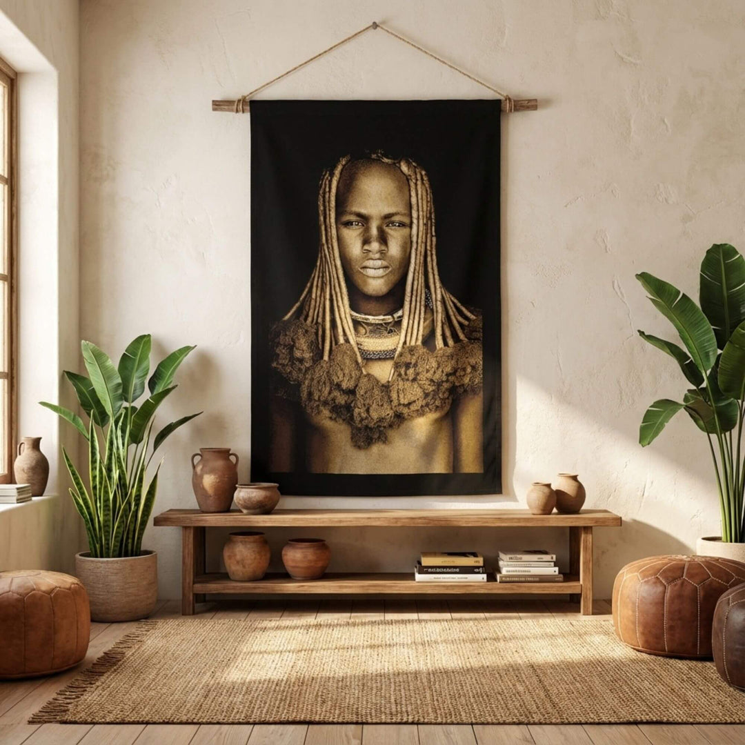 Interior styling scene showing the Himba Girl tapestry as a statement wall hanging in a living space.