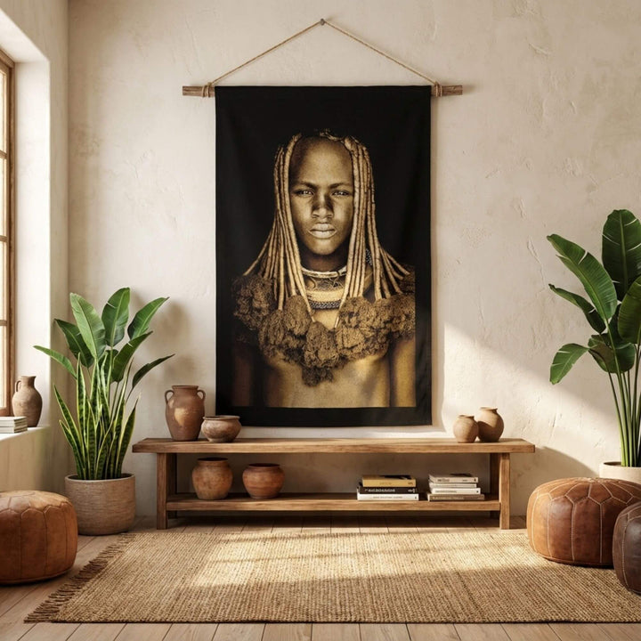 Interior styling scene showing the Himba Girl tapestry as a statement wall hanging in a living space.