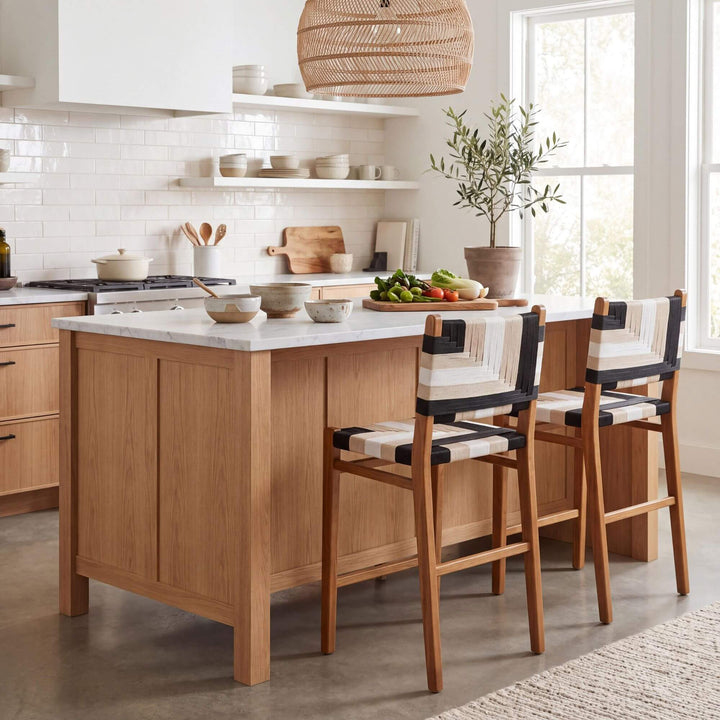 Huraa kitchen stools styled around a wooden kitchen island in a bright natural interior
