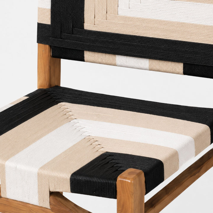 Close-up of the Huraa stool highlighting the geometric black and ivory rope weave on the seat and backrest