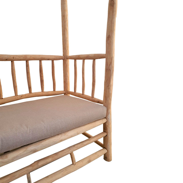 Close-up detail of the natural teak wood branches and slatted backrest construction.