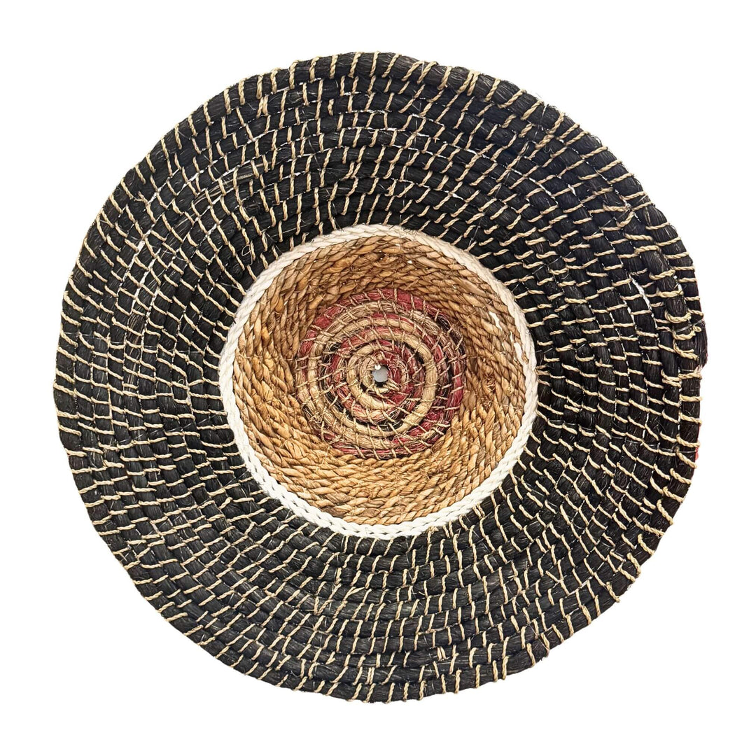 Harum Wall Deco, handwoven from abaca, rattan, and cotton in a natural and black circular design.