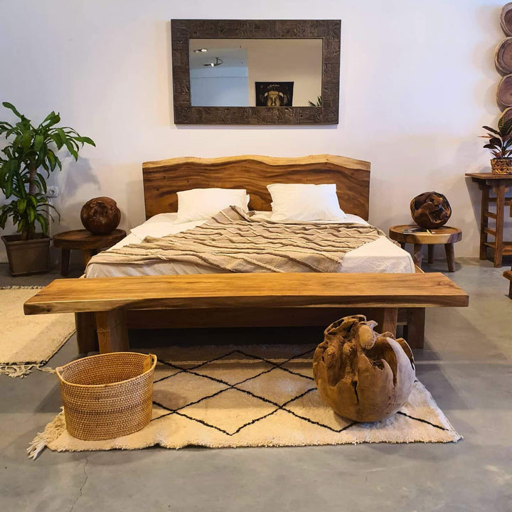 ITACA SUAR SLAB SOLID WOOD BED with matching headboard and footboard in a bedroom setting.