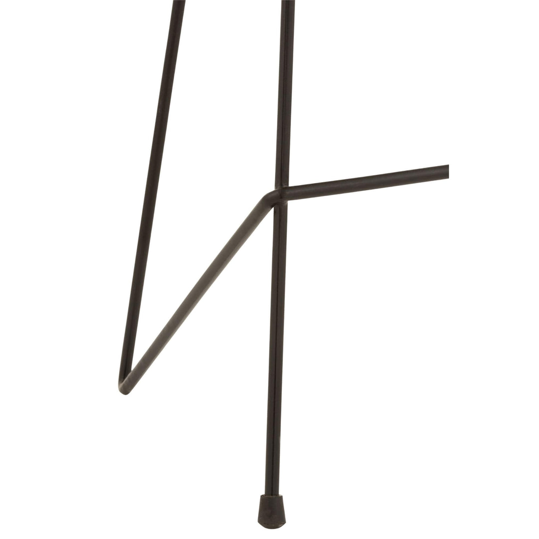 Detail of iron leg design and footrest crossbar