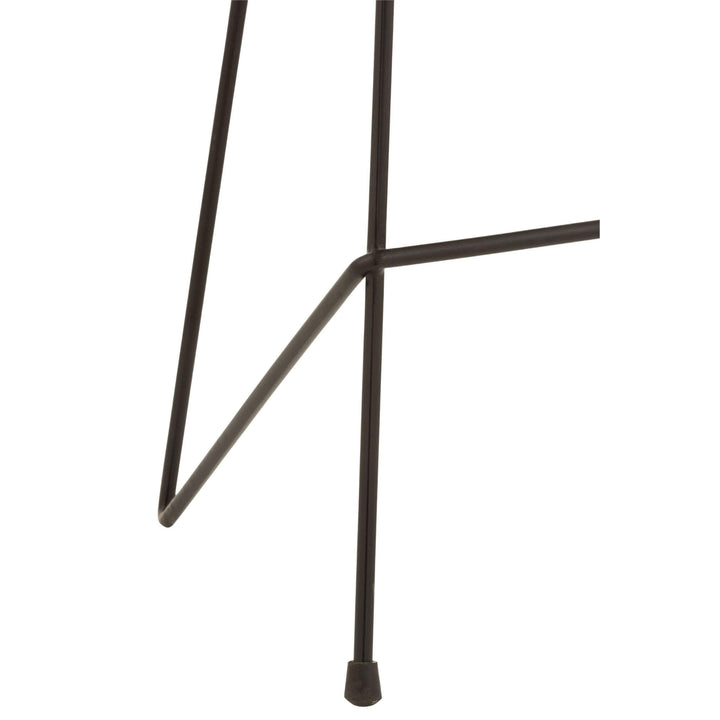 Detail of iron leg design and footrest crossbar