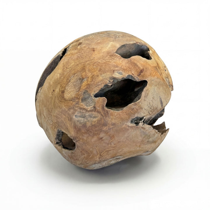 Side view of the teak root sphere highlighting natural openings and wood grain.