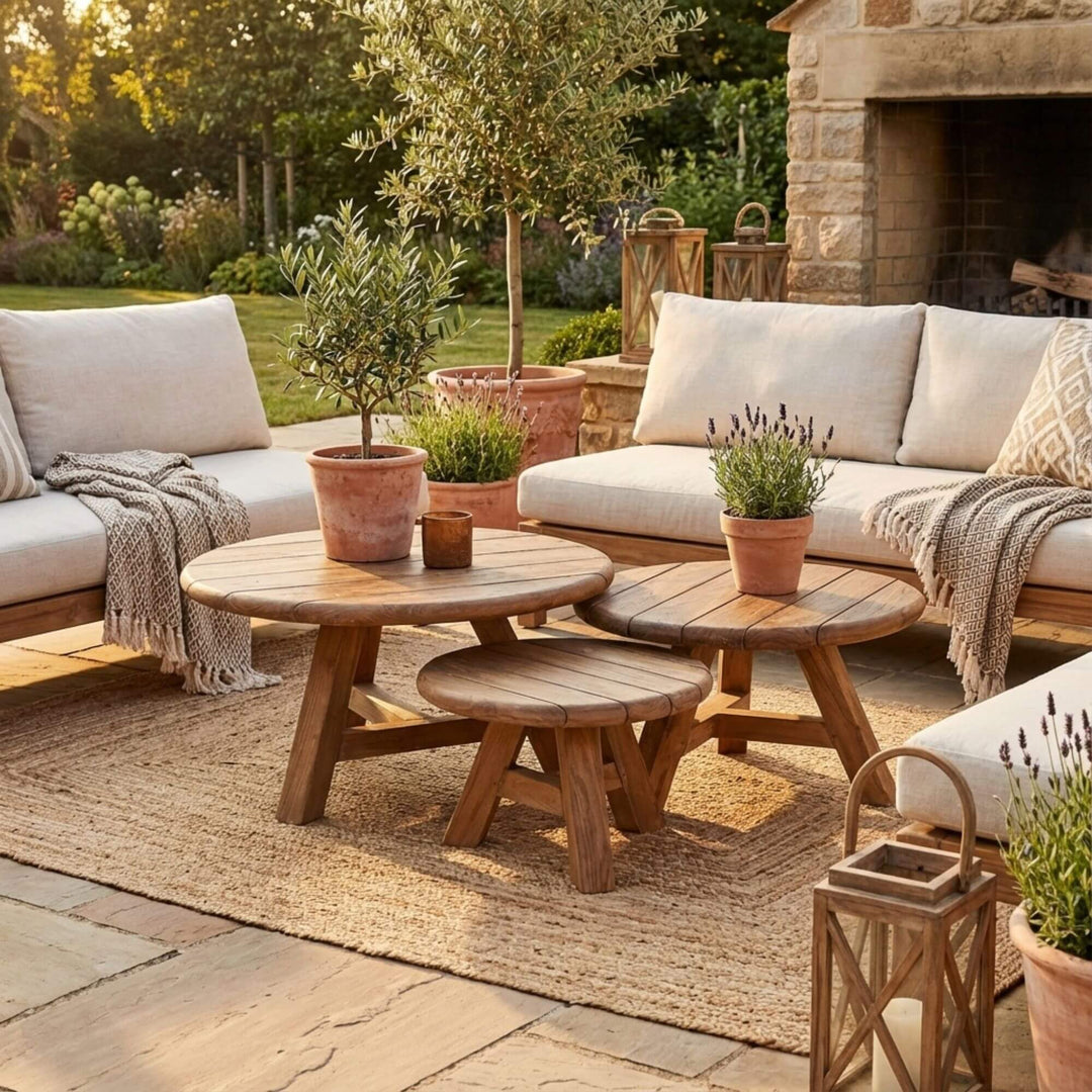 Styled outdoor view of Jati Outdoor Recycled Teak Coffee Tables arranged as a set on a terrace.