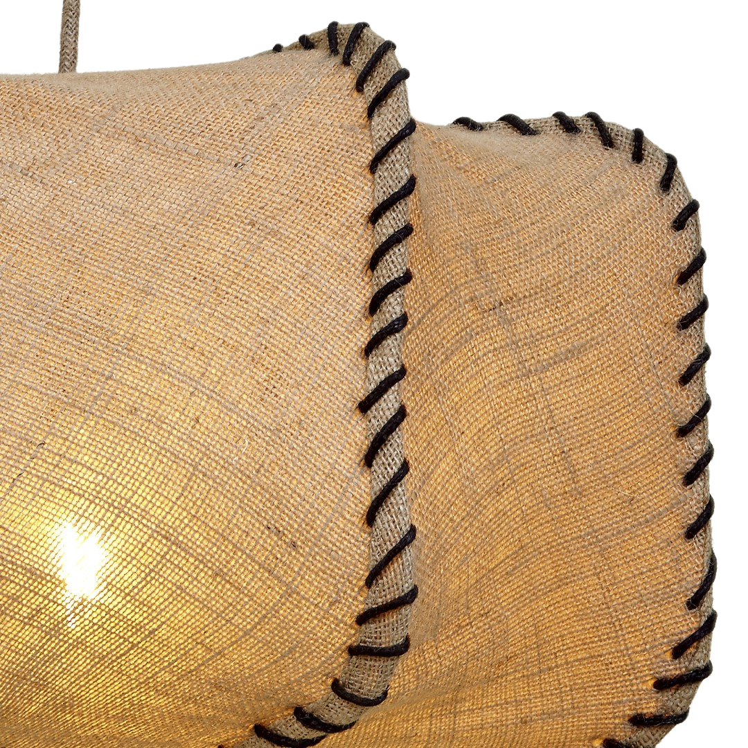 Angled view of illuminated Jutana square pendant casting warm ambient light.