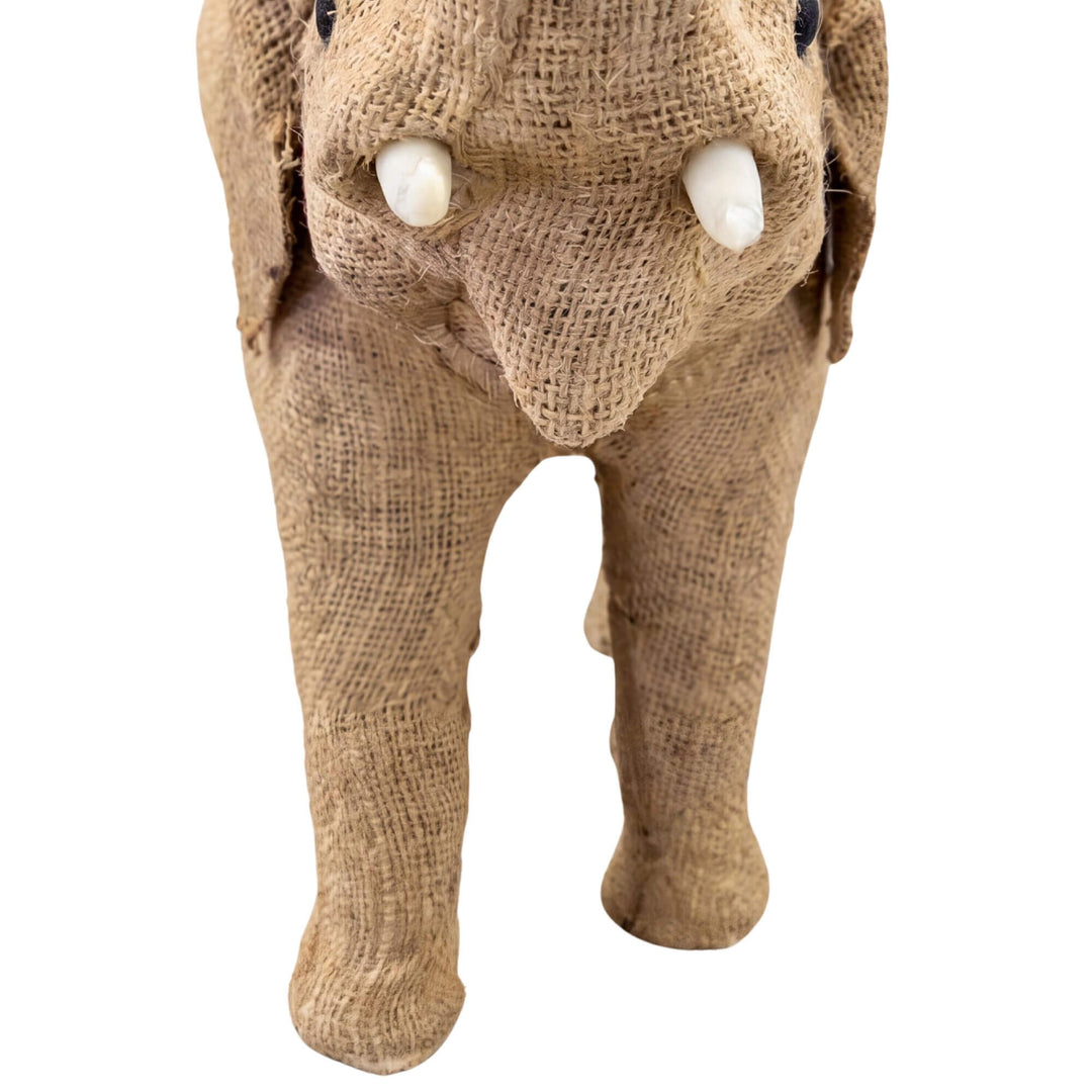 Close-up detail of the elephant face showing the woven texture, tusks, and handcrafted character.