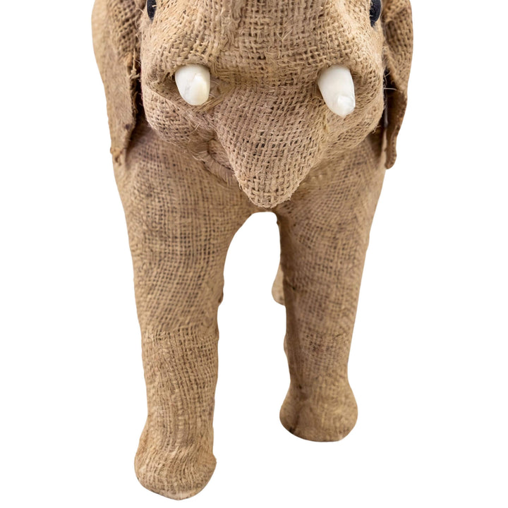 Close-up detail of the elephant face showing the woven texture, tusks, and handcrafted character.