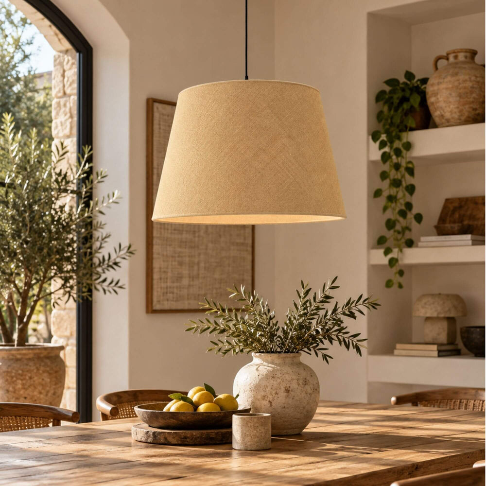 Jute lampshade suspended above a dining table in a warm Mediterranean-inspired interior