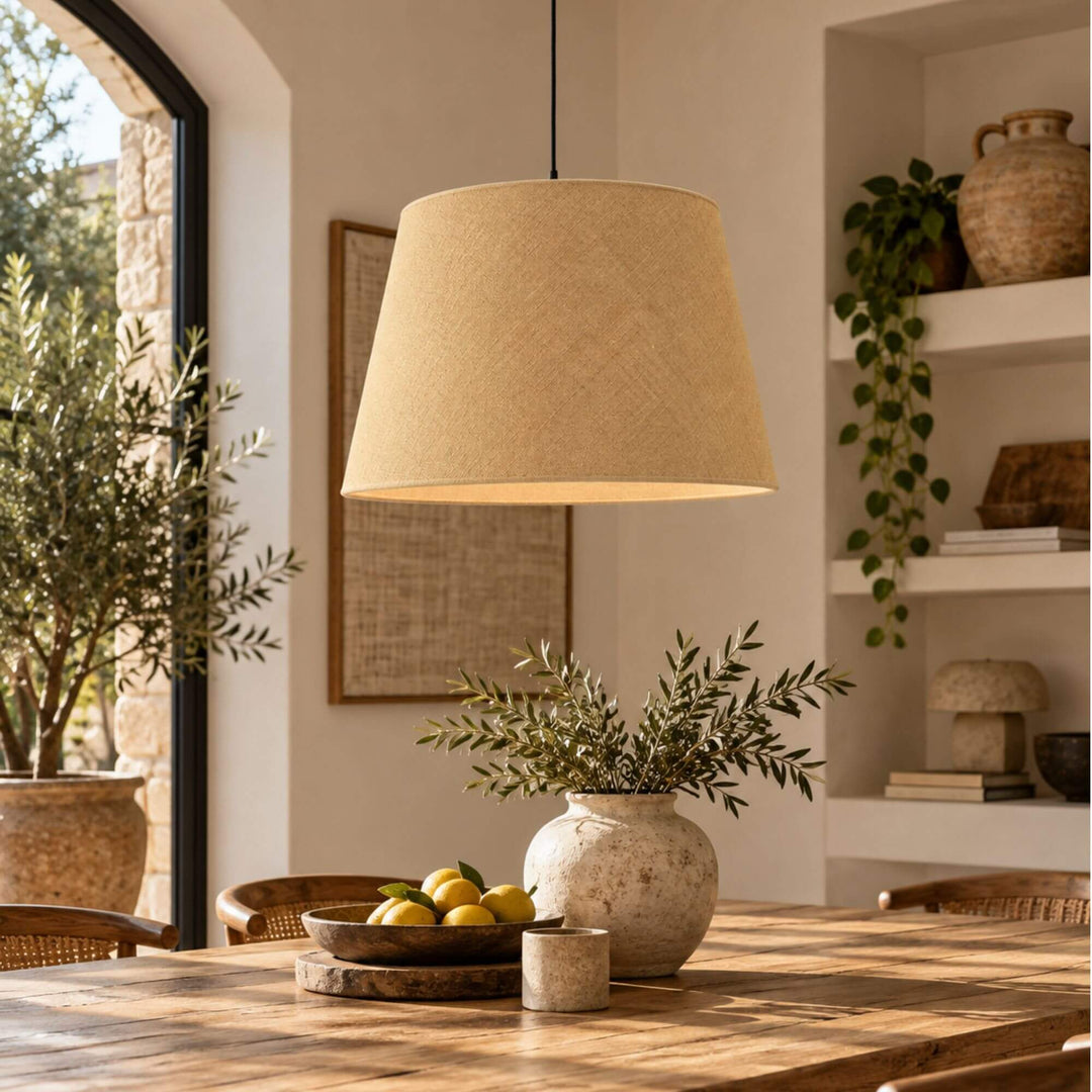 Jute lampshade suspended above a dining table in a warm Mediterranean-inspired interior