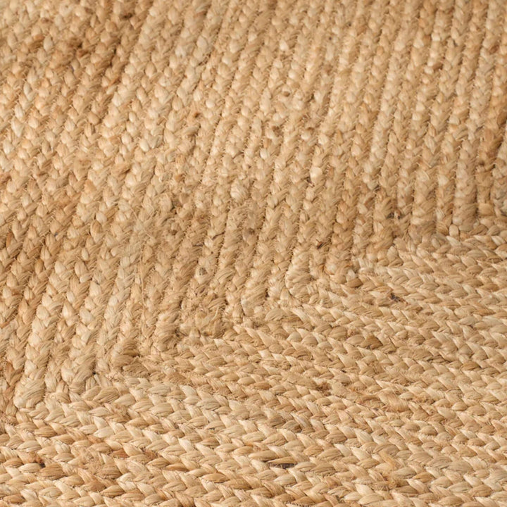 Detail of the rectangular jute rug highlighting the directional border weave and natural fiber texture