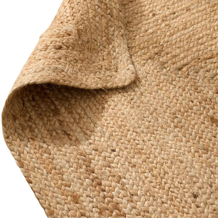 Close-up of the natural jute rug showing its thick woven fibers and textured surface
