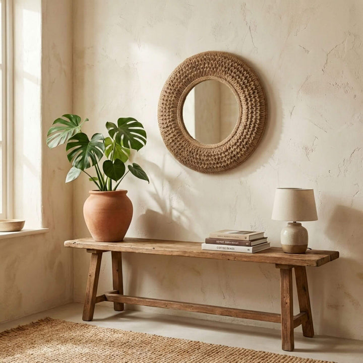 Styled interior setting featuring the jute round mirror above a wooden console table.