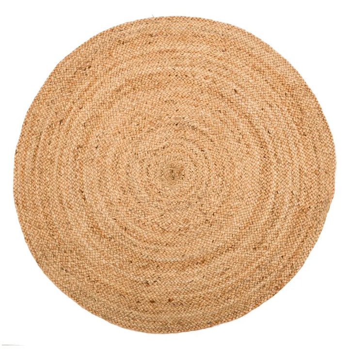 A handwooven beige jute round rug on a white background.