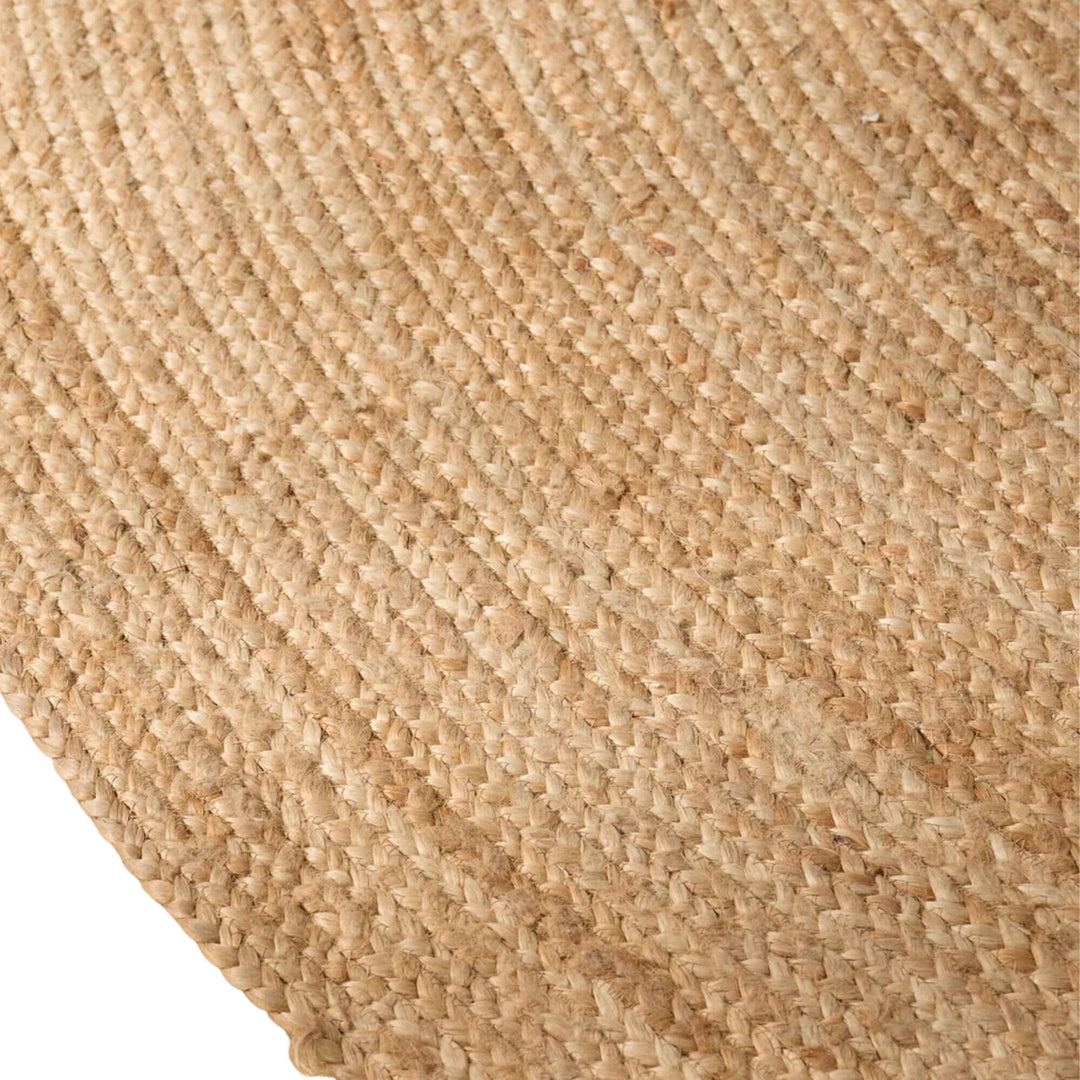 Close-up of the round jute rug showing its tightly woven natural fiber texture