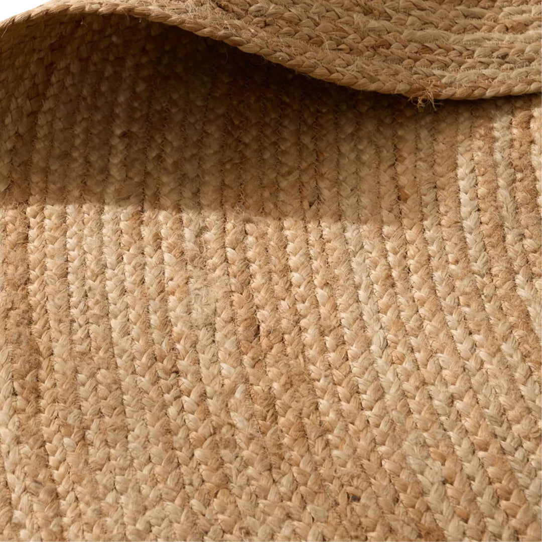 Detail view of the round jute rug highlighting the organic weave and warm earthy tones