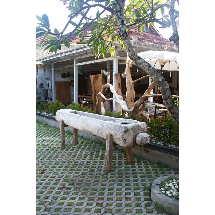 Long reclaimed teak wood trough planter displayed outdoors in front of garden showroom