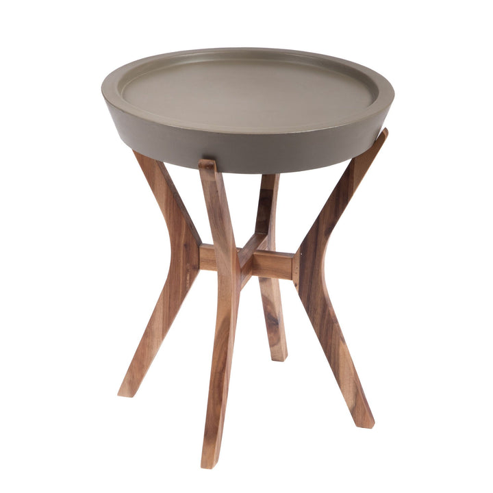 Front angled view of the Kaia side table showing its round waxed concrete tray top and sculptural curved acacia wood legs.