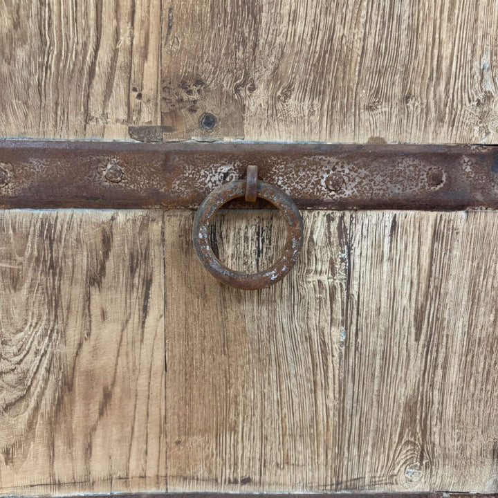 Close-up of the reclaimed wood surface and metal ring handle.