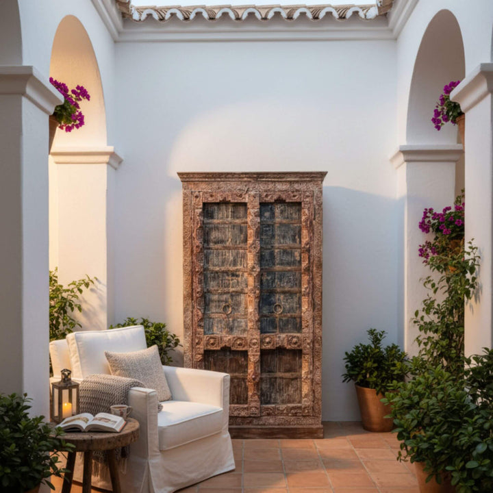 Outdoor patio setting showcasing the carved sheesham wardrobe.