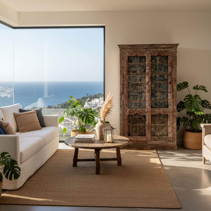 Interior view with the Kali Indian Wardrobe placed beside large windows.
