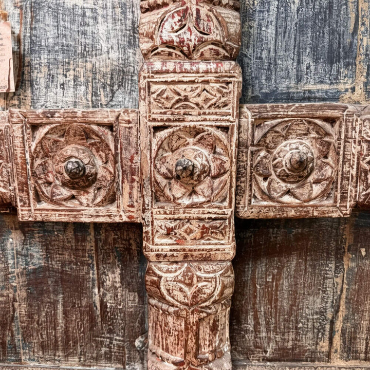 Close-up of the intricate carved details on the wardrobe doors.