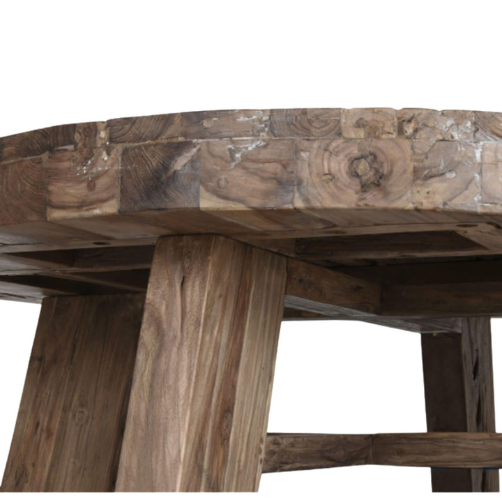 Angled view showing the thick recycled teak tabletop and wooden legs.