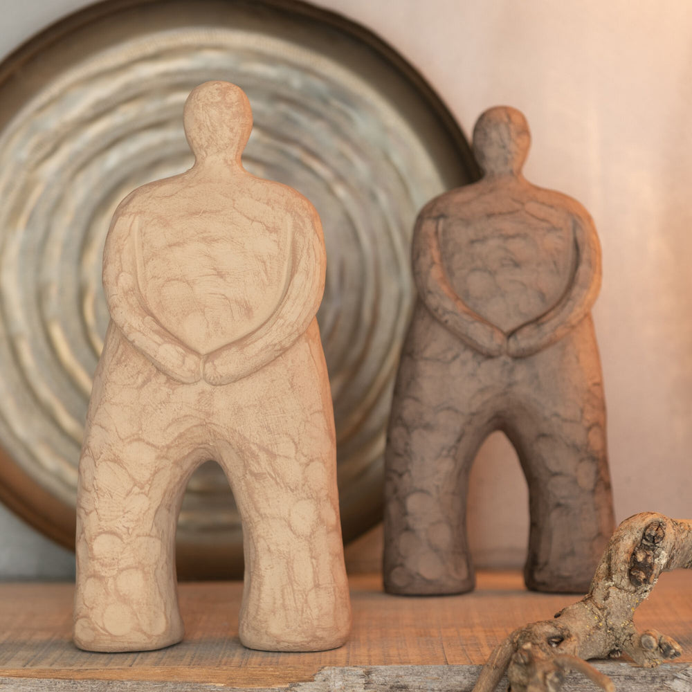 Kano figure styled on a shelf alongside neutral decorative elements.