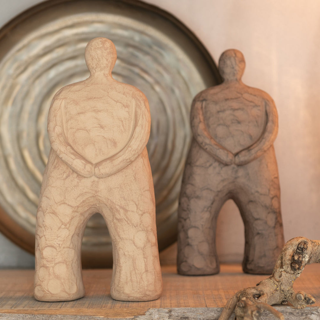 Kano figure styled on a shelf alongside neutral decorative elements.