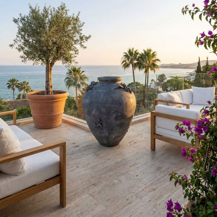 Styled terrace setting featuring the large Karekare vase overlooking a coastal view.