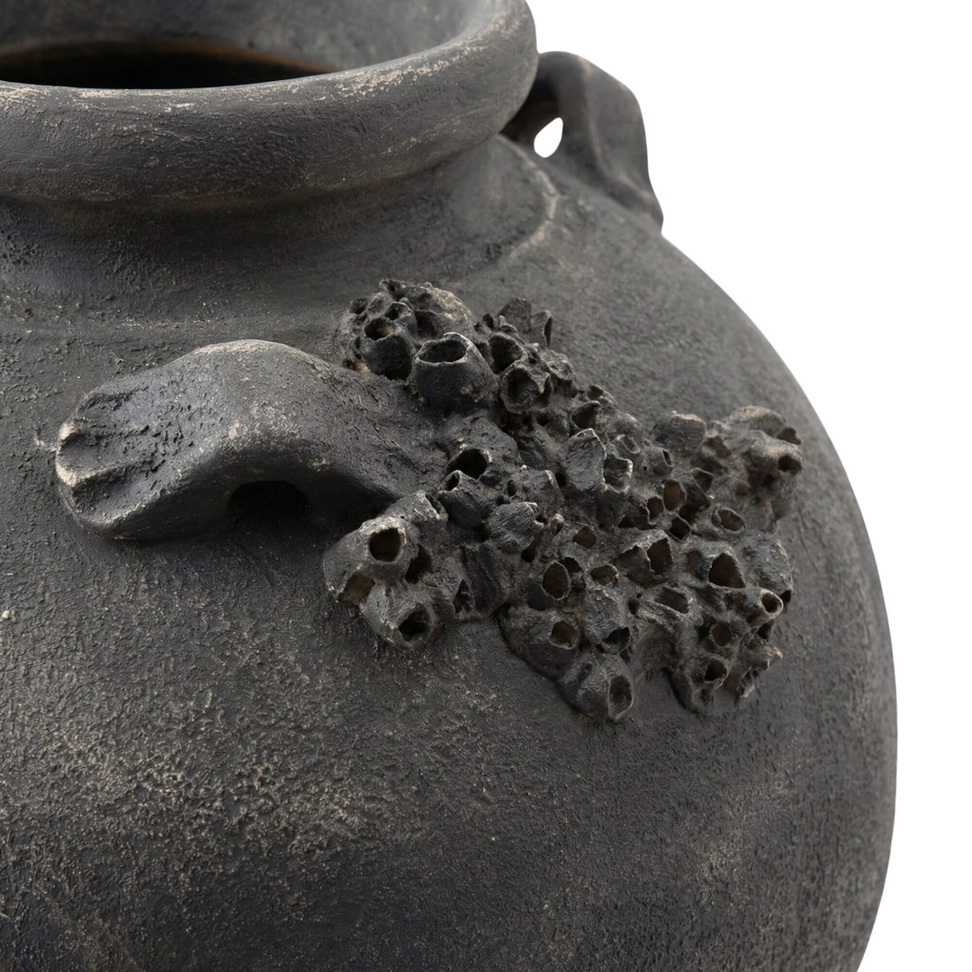 Close-up detail of the sculptural texture on the vase surface.