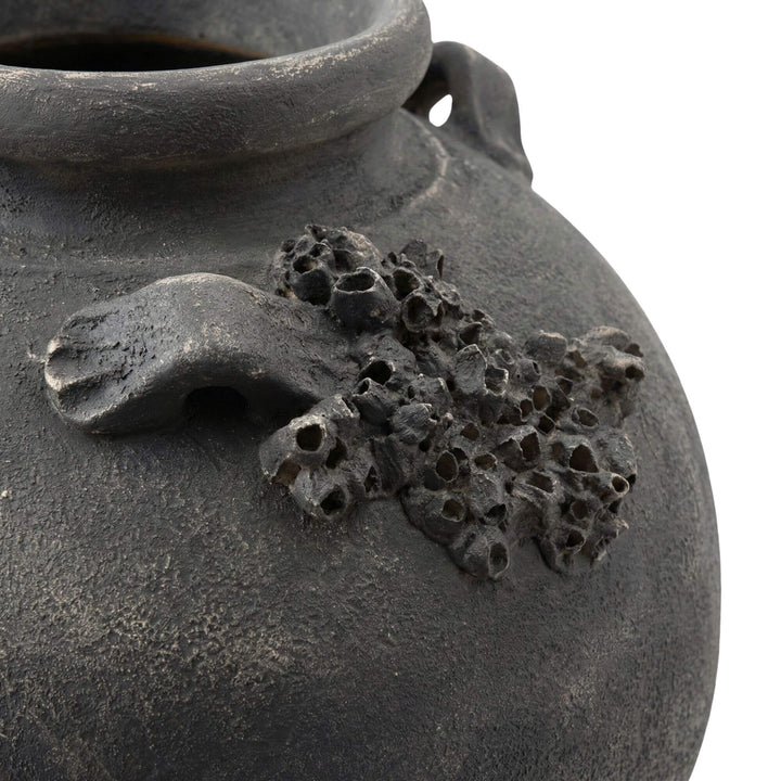 Close-up detail of the sculptural texture on the vase surface.