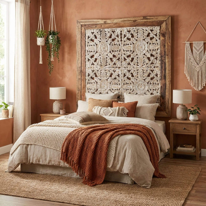 Bedroom with a large wooden Kavya wall panel headboard featuring intricate carvings, soft bedding, and decorative pillows.