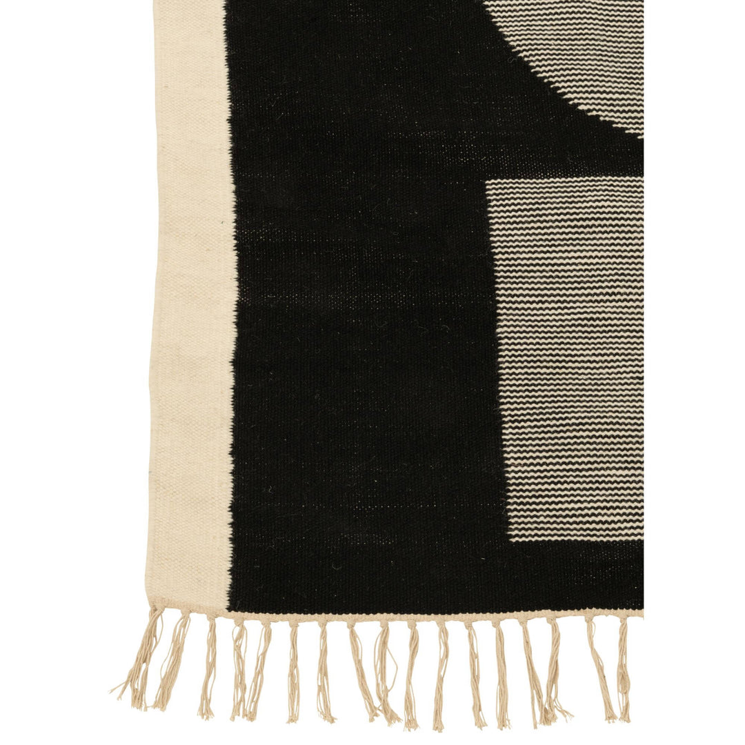 Close-up of the Kenai rug showing the geometric shapes and textured polyester surface.