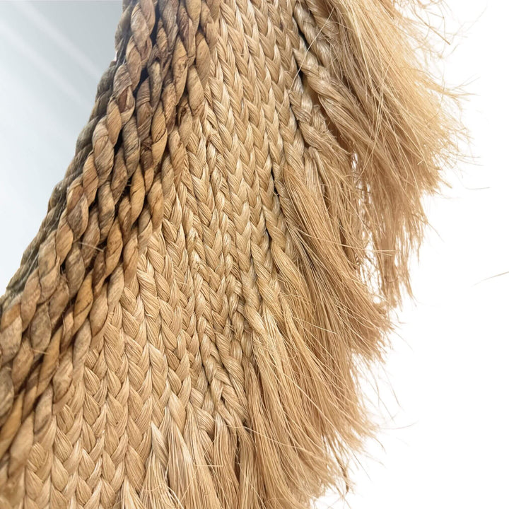 Close up of Kepang Mirror in natural abaca and sisal with fringed edges.