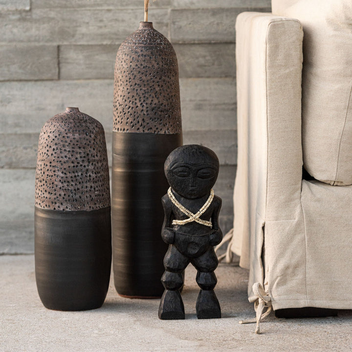 Styled interior scene featuring Khoisan wood sculptures displayed together as decorative accents.