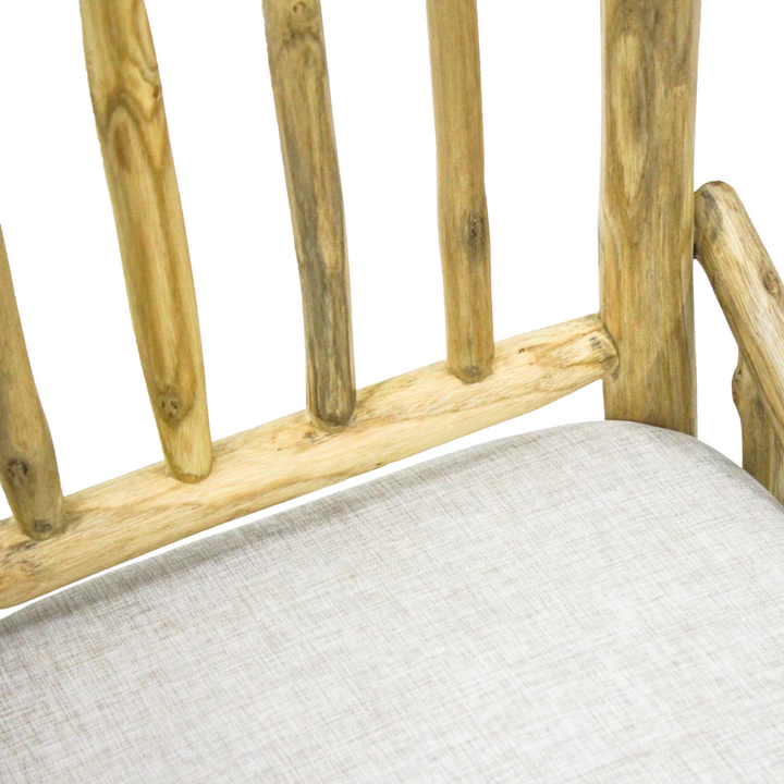 Close-up of natural teak branch joinery detail with fabric cushion