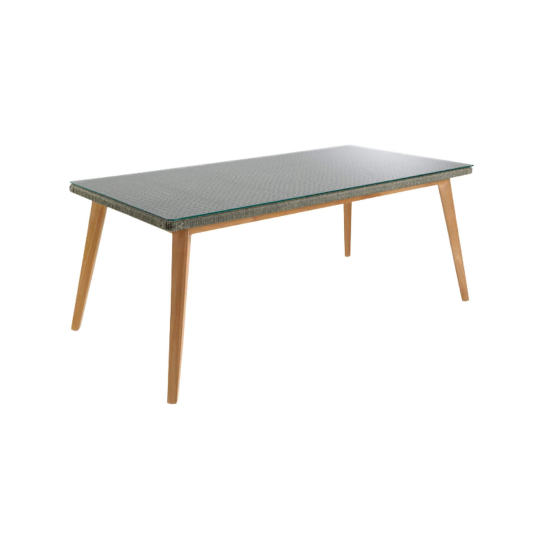Modern dining table with wooden legs and transparent glass surface