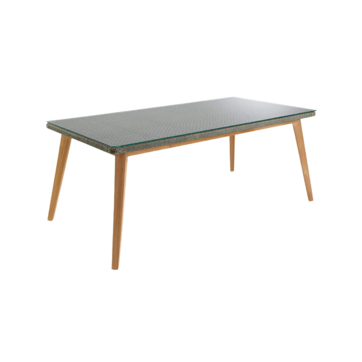 Modern dining table with wooden legs and transparent glass surface