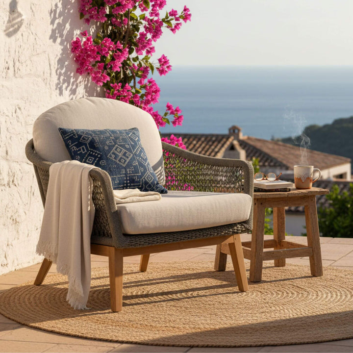 Front view of the Kodiak Collection one-seater sofa with teak frame and rope weave.