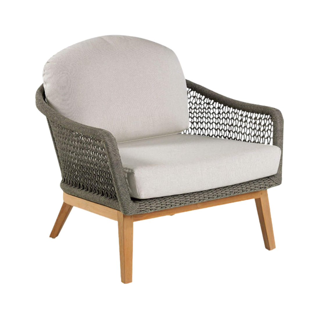 Angled view showing the rounded rope backrest and plush cushions of the Kodiak armchair.